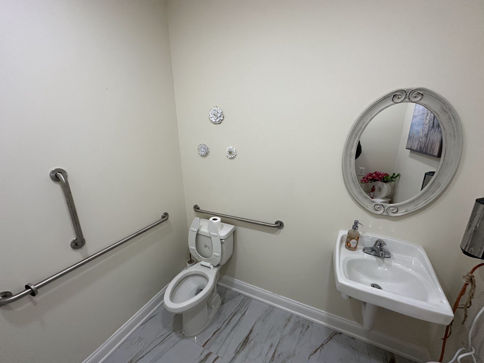 Finished powder room with pedestal sink and marble-look floor
